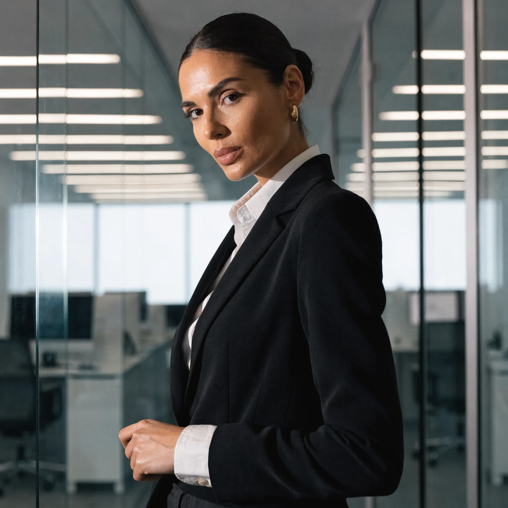 Recraft V4.1 Pro Text-to-Image: A polished commercial portrait of an adult businesswoman standing in a modern office, tailored blazer, confide