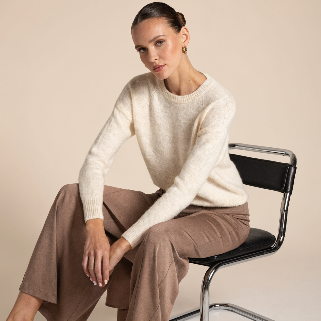 Recraft V4.1 Text-to-Image-Utility: A clean studio portrait of an adult female model against a soft beige background, natural makeup, elegant neut